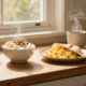 Sunlit counter with yogurt, eggs in a wrap, overnight oats, and steaming coffee.
