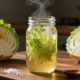 A jar of fermented cabbage sits beside cabbage, salt, and a wooden spoon.