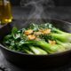 Sautéed baby bok choy with garlic and sesame in a cast-iron skillet.
