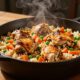 Steaming chicken thighs and vegetables rest on seasoned rice in a cast-iron Dutch oven.